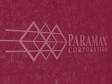 The Paramax Corporation logo on a receding wall against a red background